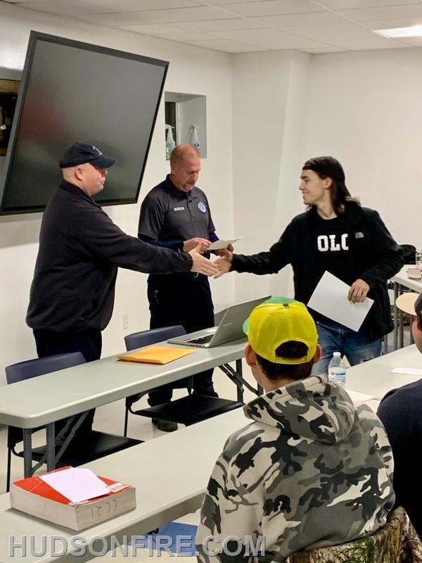 Firefighter Jaxon Haigh being presented his certification by New York State Fire Instructor Daniel Hickey Jr., who is also a City of Hudson Firefighter and past Captain.